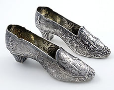 pair of German silver shoes with romantic scenes by Neresheimer retailed by Berthold Mueller